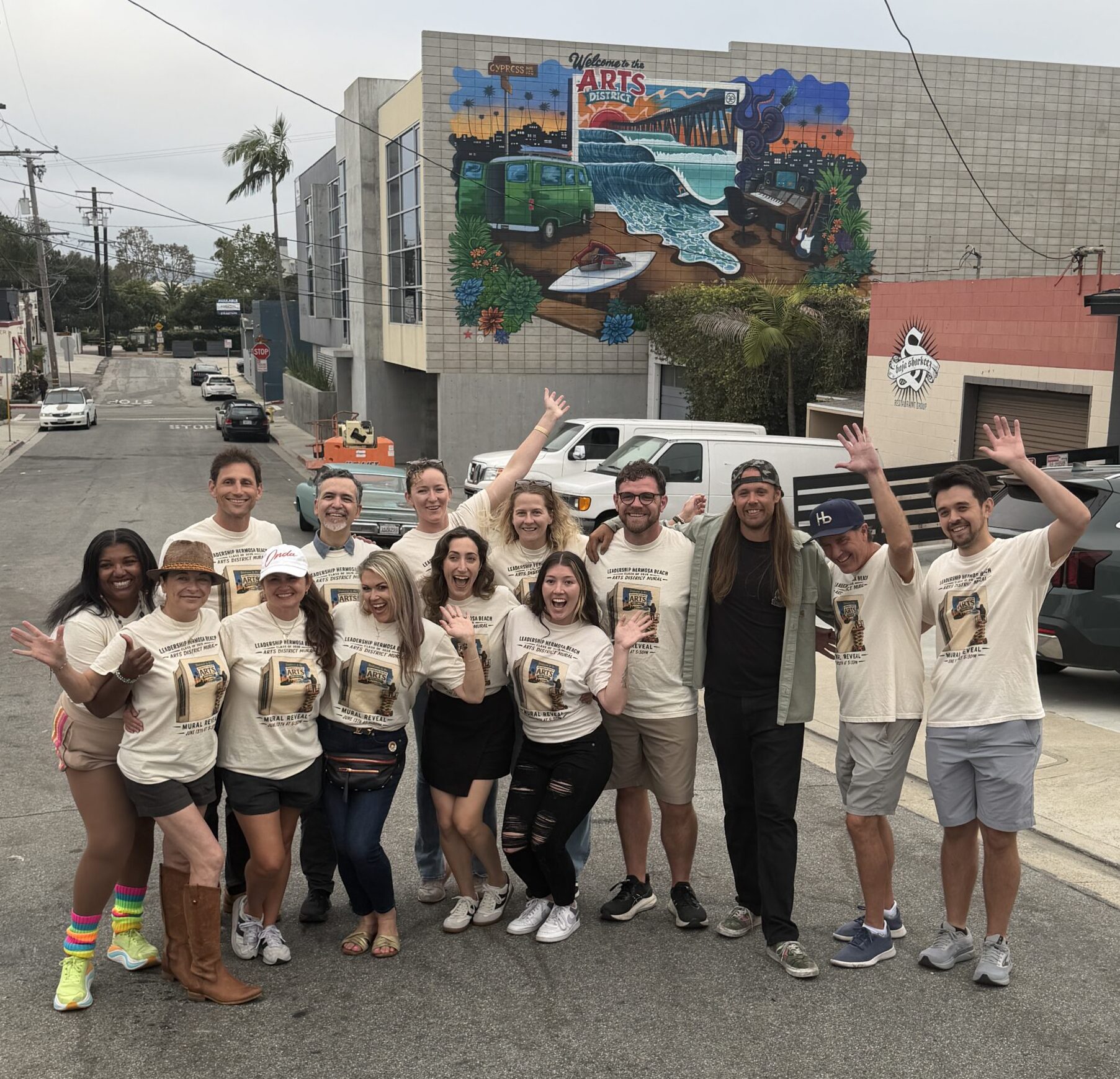 Group photo of class of 2026 in front of their mural